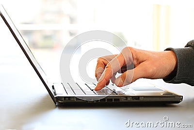 Close-up image of a finger touching texting on keyboard on a laptop computer. Stock photo with white background for copy Stock Photo