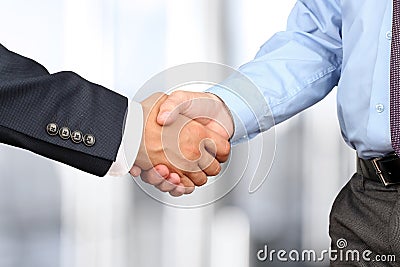 Close-up image of a firm handshake between two colleagues in off Stock Photo