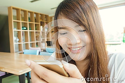 Close-up image of hipster girl sitting at vintage cafe and using modern smarphone, female hands typing message on mobile phone. Stock Photo