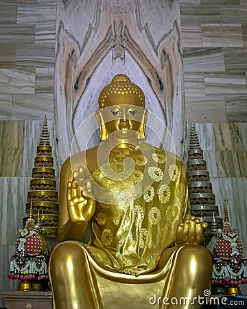 Close up image of Huge golden statue of sitting Buddha outside Thai temple in Sarnath near Varanasi Stock Photo