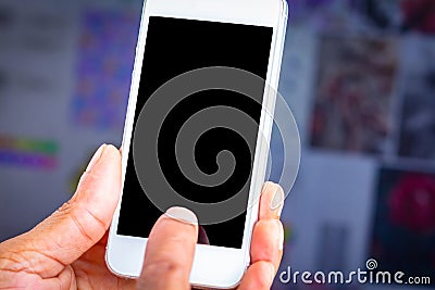 Close-up image male hand holding white smartphone with blank black desktop screen Stock Photo