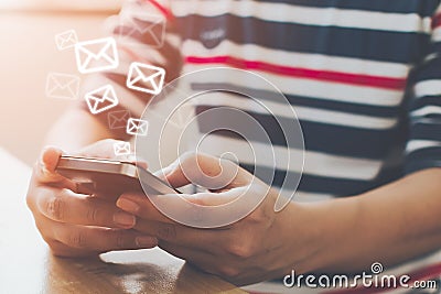 Close-up image of male hands using smartphone with icon envelope email Stock Photo