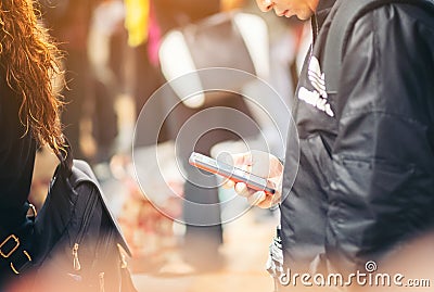 Close-up image of male hands using smartphone at night on city shopping street, searching or social networks concept, hipster man Stock Photo