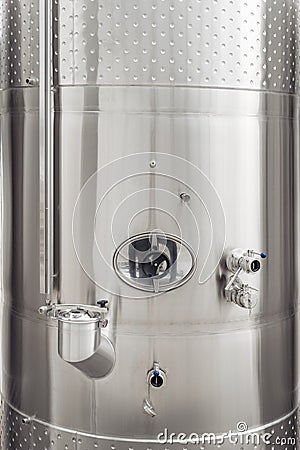 Close-up image of modern stainless steel barrel for wine fermentation at a winery. Wine industry. Stock Photo