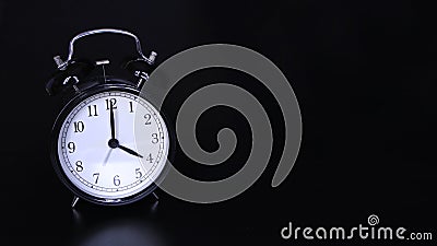 Close up image of old black vintage alarm clock. Four o`clock Stock Photo