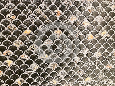 Close-up image of a patterned collection of circular metallic objects, possibly currency or decorations, with slight Stock Photo