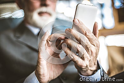 Close up image of senior businessman using mobile phone. Stock Photo