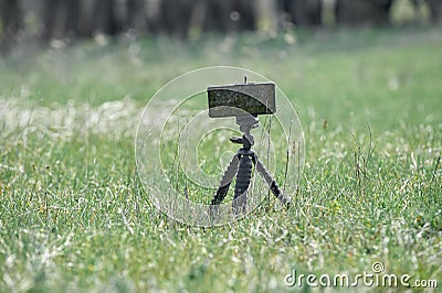 Close-up image of smartphone take a landscape photo on flexible tripod Stock Photo