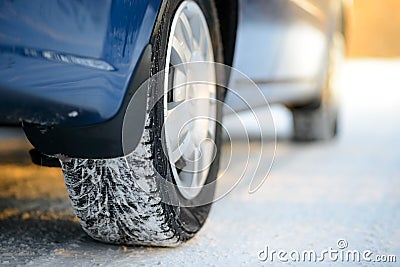 Close-up Image of Winter Car Tire on the Snowy Road. Drive Safe. Stock Photo