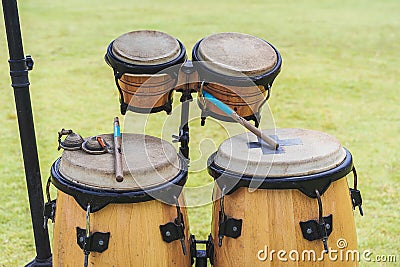 Close up image of wooden ethnic drums on green background. Stock Photo
