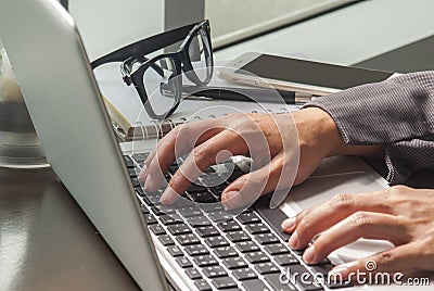 Close-up image of a young woman who is typing on a laptop Stock Photo