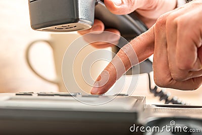 Close up Index Finger Dialing on Black Telephone Stock Photo