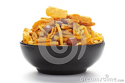 Close-Up of Indian spicy snacks Namkeen - All in one in a black Ceramic bowl, made with fried peanut, corn flakes, sweet pea, Stock Photo