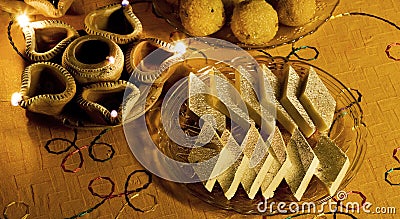 Close up of Indian Sweets and Diwali Lamps Stock Photo