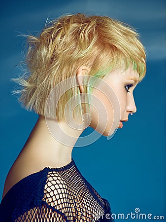 Close-up indoor portrait of lovely girl with blonde hair. Studio shot of graceful young woman with short haircut Stock Photo