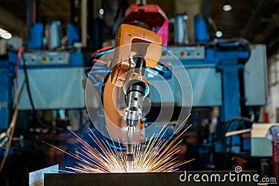 Close-up industrial robot is welding in a car factory Stock Photo