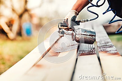 Industrial worker using paint gun or spray gun for applying paint Stock Photo