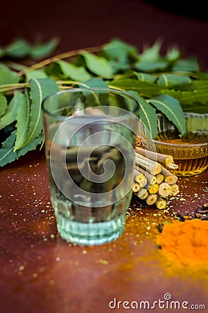 Close up of ingredients of ayurvedic treatment i.e neem,neem leaves,neem powder,bark,clove,turmeric,water. Stock Photo