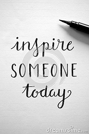 Close-up of `INSPIRE SOMEONE TODAY` hand-lettered in notebook Stock Photo