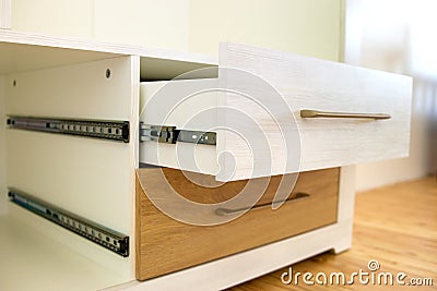 Close up of installation of wooden drawer in contemporary cupboard cabinet Stock Photo