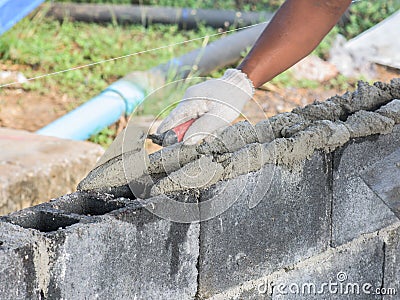 Close up of installing bricks in construction site by industrial bricklayer Stock Photo