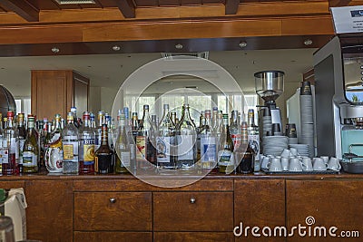 Close up interior view of bar with different sorts of alcohol and coffee machine. Editorial Stock Photo