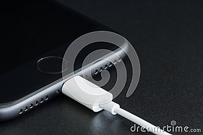 Close-up iPhone 7 matte black connect to usb cable Stock Photo