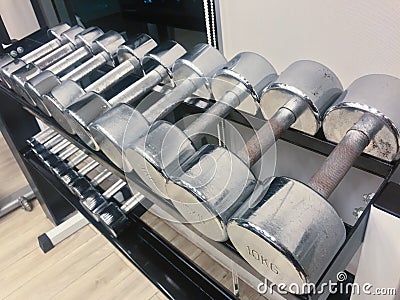 Close up Iron dumbbell have slightly rusted for workout on shelf Stock Photo