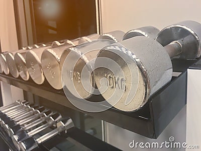 Close up Iron dumbbell have slightly rusted for workout on shelf Stock Photo
