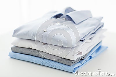 Close up of ironed and folded shirts on table Stock Photo