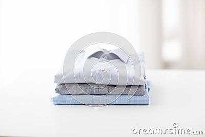 Close up of ironed and folded shirts on table Stock Photo