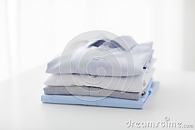 Close up of ironed and folded shirts on table Stock Photo