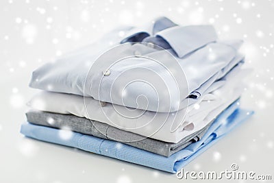 Close up of ironed and folded shirts on table Stock Photo