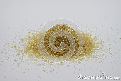 Close up of isolated pile brown sugar crystals, white background Stock Photo