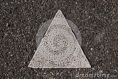 Close up of a isosceles triangle painted with thick white paint on the asphalt Stock Photo