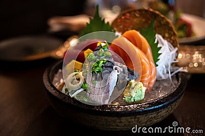 Close-up of Japanese food mixed Sashimi dish on blurred background, thinly sliced raw fish seafood served on ice with a little bit Stock Photo
