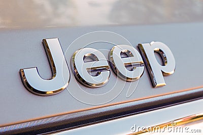 Close up of Jeep logo on the SUV auto. Jeep is a brand of American automobiles, FCA US LLC Editorial Stock Photo