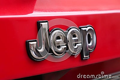 Close-up of jeep metallic logo on red vehicle Editorial Stock Photo
