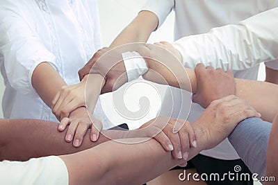 Close up of joining hands of businessman in unity cross processing background Stock Photo