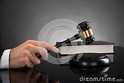 Close-up Of Judge Hitting Gavel Stock Photo