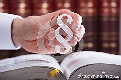 Judge Holding Paragraph Symbol Stock Photo