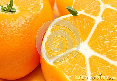 A close-up of a juicy, ripe orange, its textured peel glistening with citrus oils. Stock Photo