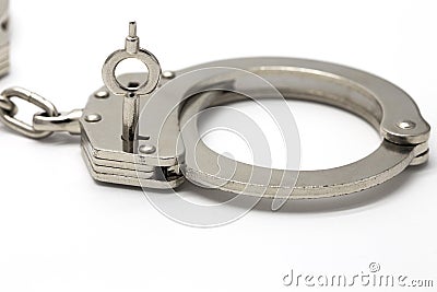 Close-up of key in handcuffs Stock Photo