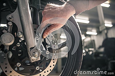 Close up of hand with key near the motorcycle`s vehicle Stock Photo