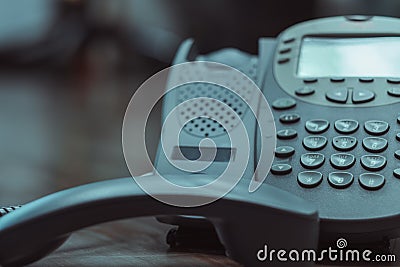 Close Up keypad number analog phone is placed on a wooden floor in the office Stock Photo