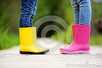 Close up of kids legs in wellington boots Stock Photo