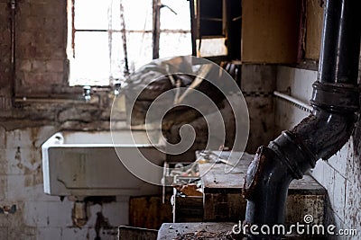 Close up of kitchen left in appalling condition in derelict 1930s deco house. Rayners Lane, Harrow UK Stock Photo