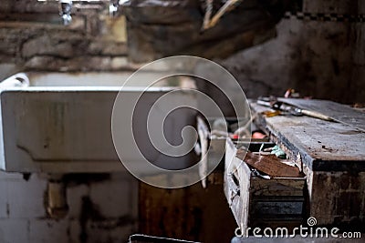 Close up of kitchen left in appalling condition in derelict 1930s deco house. Rayners Lane, Harrow UK Stock Photo