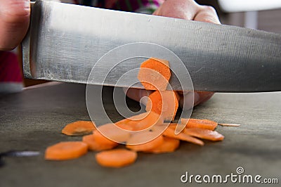 Close Up of Knife Slicing Carrots Stock Photo