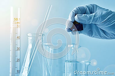 A close-up of a laboratory glass, Dropping substances Stock Photo